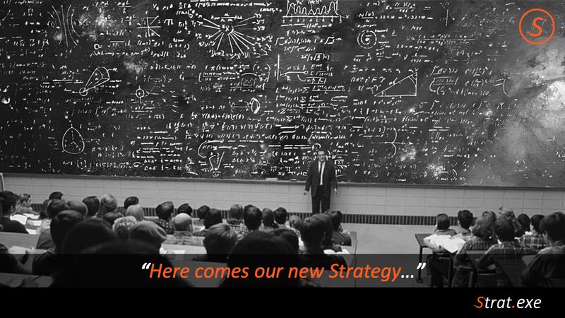 A presenter in front of a blackboard covered in equations, “Here comes our new Strategy…”